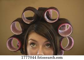 A woman with curlers in her hair
