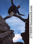 Hiker jumps across a gap