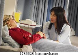 Nurse sitting with patient