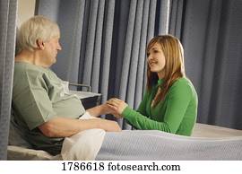 Woman visiting senior in hospital room