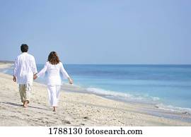 Couple walking on beach Couple walking on beach