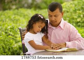 Father and daughter in prayer