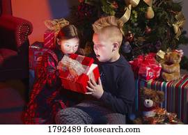 Child opening Christmas present Stock Photo  1780257  Fotosearch