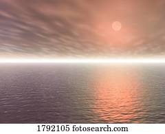 Sunset over an expanse of water and sky