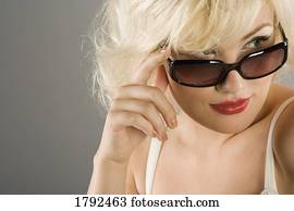 Woman looking over sunglasses