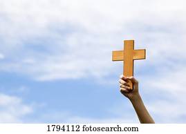 Person holding up a cross