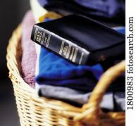 Bible on top of laundry folded in basket
