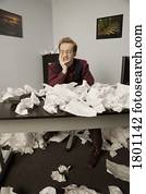 Businessman with crumpled papers in office