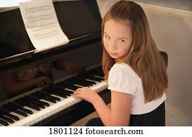 Girl practising piano  