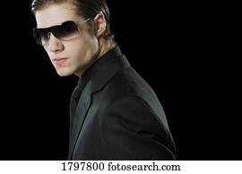 Man wearing a suit and sunglasses