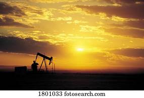 Oil well in a sunset