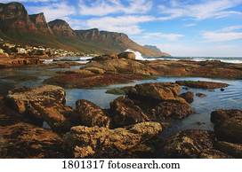 Rocky seashore with mountainous background