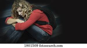 Sad girl sitting alone