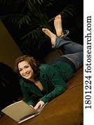 Woman laying down and working on laptop