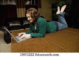 Woman laying down working on laptop