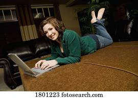 Woman laying down working on laptop