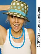 Woman wearing a hat and necklace