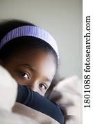 Young girl with head resting on arms