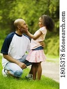 Side view of father with daughter in park