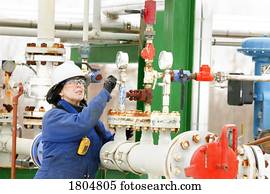Woman working on a boiler system