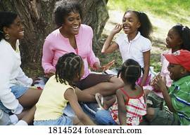 A group of people sitting in the park A group of people sitting in the park