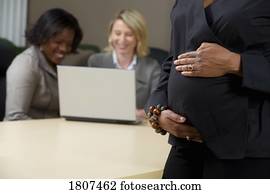 Pregnant business woman in the office