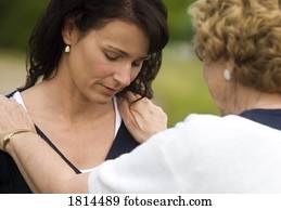 Senior woman consoling young woman
