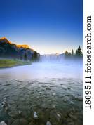 Sunrise and early morning mist on mountain river