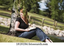 A woman reading in the park A woman reading in the park
