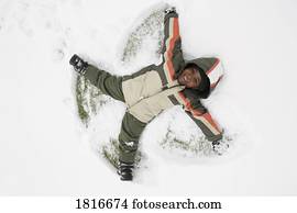 High angle view of a boy lying on snow