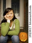 Young girl with carved pumpkin