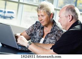 A couple working on a laptop