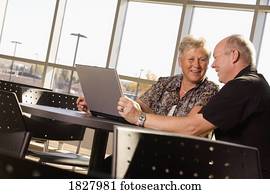 Senior couple working on laptop