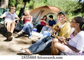 Group of young people at a campsite Group of young people at a campsite