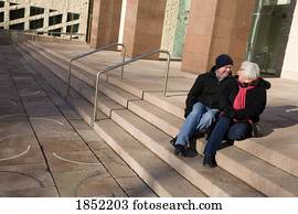 Senior couple; Couple sitting on steps and talking