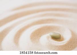 Single pebble in sand