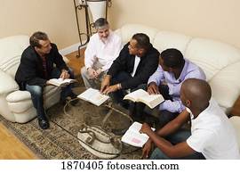 a group of men in a home bible study