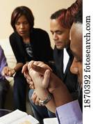 adults praying together with their bibles open adults praying together with their bibles open