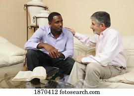 men talking together with a bible open men talking together with a bible open