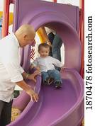 parents at the playground with their young son