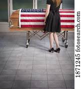 paying respects to the deceased with an american flag draped over the coffin