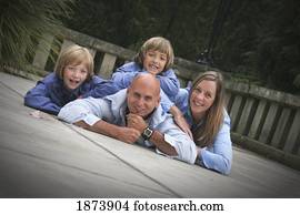 a family portrait with members laying down on the deck