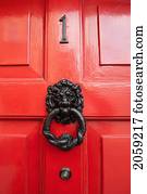 Lion Door Knocker On A Red Shiny Door; Ireland