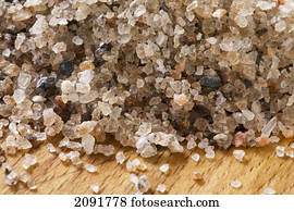 Close up of rock salt on a wooden cutting board; calgary, alberta, canada