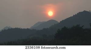 Glowing sunlight over the mountainous landscape; Beijing, China