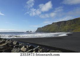 Black Lava Beach With Basalt Stacks Of Reynisdrangar In The Background; Vik, Vestur-Skaftafellssysla, Iceland
