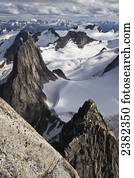 A climber descending the Kaine Route on Bugaboo Spire, Purcell Range, Columbia Mountains; British Columbia, Canada