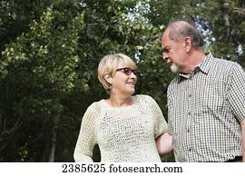 A senior couple talking in a park; Stony Plain, Alberta, Canada