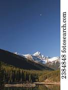 Mountain lake, blue sky, and snow-capped mountains; Alberta, Canada