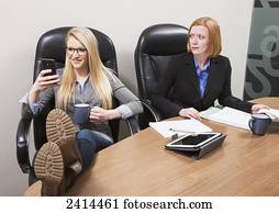 Co-worker texting with surprised boss watching; Edmonton, Alberta, Canada